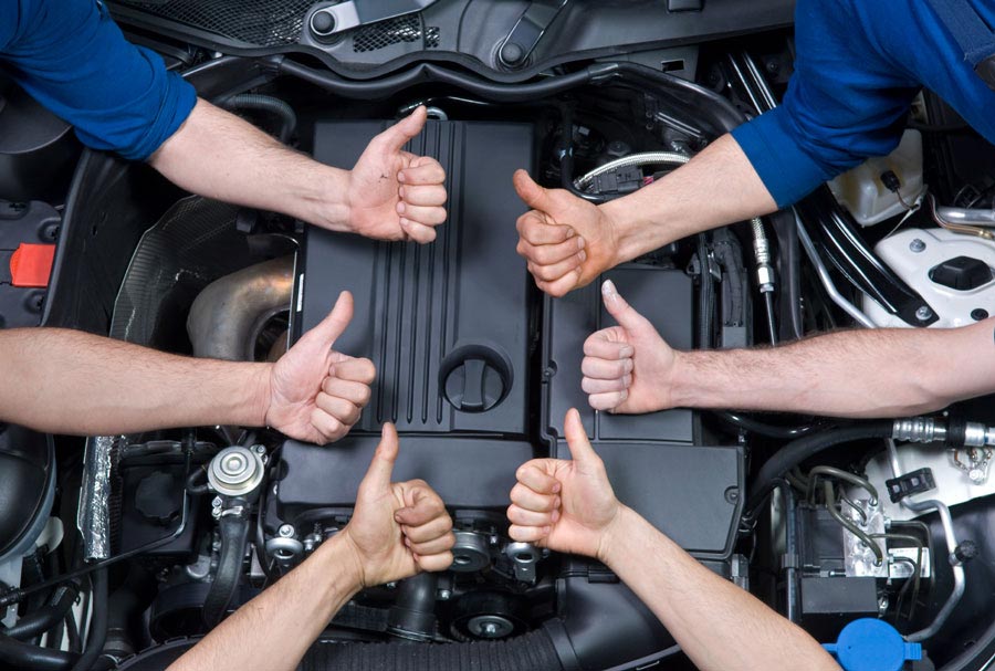 Automotive Technicians with Thumbs-up in Engine Compartment